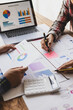 © Wasan - Businessman meeting with financial advisor, discussing analysis of financial charts in business report and planning company budget.