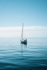 Wall Mural - Sailboat floats serenely on calm blue ocean.