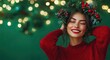 © thiquynh - a happy young woman wearing a Christmas wreath on her head, winking with one hand touching her face against a green background.
