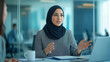 © Nataliya - Arab Woman Manager Leading Discussion in Modern Office