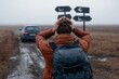 © Milos - A traveler stands at a fork in the road, facing uncertainty with a backpack, unsure of which direction to take amidst fog and desolate landscape. It depicts the struggle of choices.