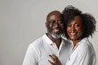 © Markus Schröder - Portrait of a merry afro-american couple in their 30s wearing a classic white shirt in blank studio backdrop