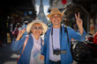 © SKW - Asian retired couple happily hang out together in city full people city full buildings in capital Thailand Bangkok