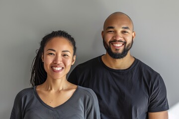 Wall Mural - Portrait of a happy multiethnic couple in their 30s sporting a breathable mesh jersey isolated in plain cyclorama studio wall