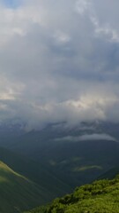 Wall Mural - beautiful landscape with mountains and clouds in dusk, caucasus, russia, timelapse. vertical video
