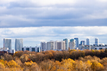 Wall Mural - low blue gray clouds over colorful city park