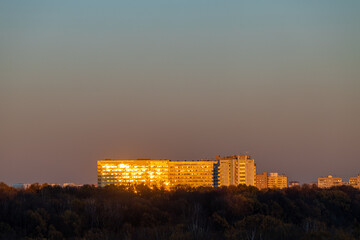 Wall Mural - house in city park illuminated by sunset sun