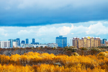 Wall Mural - large blue snow cloud over houses and city park
