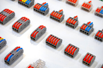 Wall Mural - Terminals for connecting wires. Mini connectors for electrical cables. Terminals of different sizes on white. Connectors for electrical equipment. Connecting terminals for mounting sockets