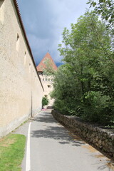 Wall Mural - Cycling route close to Glurns, city wall- Cycling the transalpine route Via Claudia Augusta