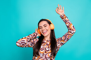 Wall Mural - Photo of adorable lovely girl wear print shirt enjoying song earphones empty space isolated turquoise color background