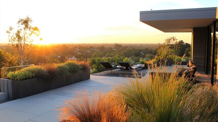 Canvas Print - A serene sunset view from a modern terrace with lounge chairs and lush landscaping.