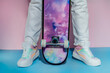© okrasiuk - Female legs in white jeans and retro style high-top multicolor sport sneakers shoes standing with skateboard on blue pink background. Vintage retro fashion style of 80s - 90s vibes. Active lifestyle