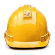 © wasan - A worn yellow hard hat symbolizing safety in construction work. isolated on white background.