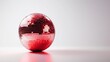 © Albert - a red disco ball on a white background, creating a vibrant and eye-catching contrast The ball is spherical in shape and has a glossy finish, reflecting the light a