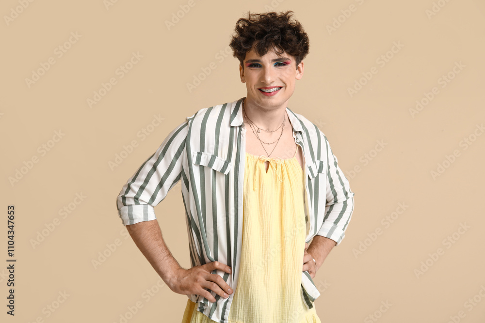 Young transgender woman on beige background