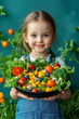 © stanhert - A little girl holding a bowl of fresh vegetables in her hands