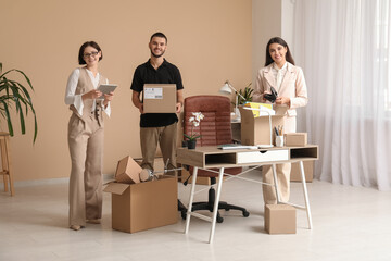 Wall Mural - Business colleagues with cardboard boxes in office on moving day