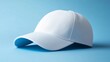 © Oleg - Simple white baseball cap on a blue background for casual wear and fashion