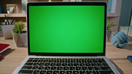 Wall Mural - Hand browsing website greenscreen laptop at home closeup zoom in. Unknown man