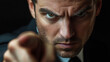 © Pisahouse - A determined man dressed in a suit intensely points at the viewer, conveying authority and focus in a dramatic close-up.