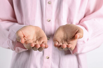 Wall Mural - man holding something on light background, closeup