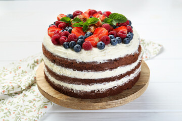 Wall Mural - Delicious chocolate sponge cake with berries on light table