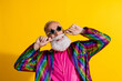 © deagreez - Portrait of eccentric funky aged man curl mustache wear shiny costume isolated on yellow color background