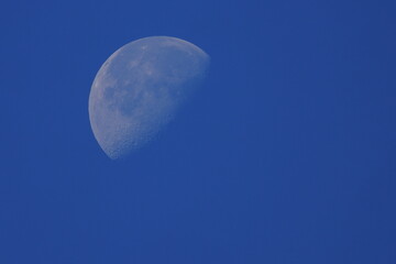moon and clouds blue sky