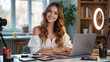 © Juan Mari - A smiling woman sits at a desk surrounded by makeup products and a laptop, ready for a beauty tutorial. Perfect for beauty blogs, online courses, and lifestyle content, copy space, blank