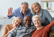 © Prostock-studio - Multiracial group of happy positive elderly people men and women in casual outfits taking selfie together while chilling together, hugging and smiling at camera, nursing home interior