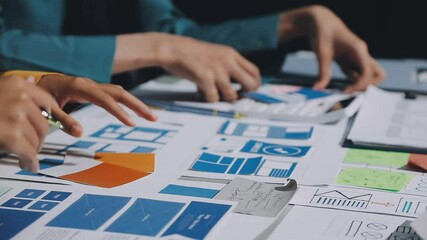 UX developer and ui designer brainstorming about mobile app interface wireframe design with customer breif and color code. business working