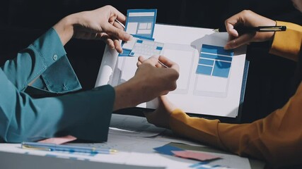 Wall Mural - ux developer and ui designer brainstorming about mobile app interface wireframe design with customer