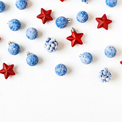 Wall Mural - A festive arrangement of blue and red Christmas ornaments on a white background