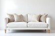 © Vitaliy - A white upholstered sofa with pillows on the background of an empty wall. Sofa in a new apartment after cleaning