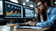 © NOPPHINAN - Focused business professionals analyzing financial charts and graphs on dual monitors in a modern office, showcasing teamwork and data-driven decision-making