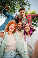 group of happy teenagers smiling and having fun outdoors, enjoying friendship and diversity while ta