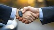 © Galib - Two people shake hands while one hands over the keys to a new car.