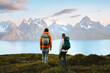 © EVERST - Couple enjoying mountains landscape in Norway friends man and woman hiking with backpack, active vacations healthy lifestyle outdoor family adventurers exploring trails in Lyngen Alps survival trip
