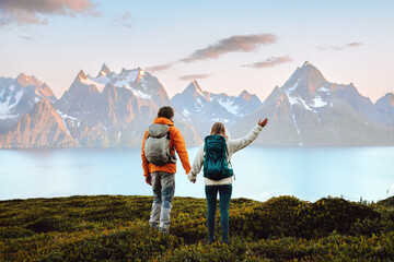 couple in love hiking travel in norway man and woman friends holding hands enjoying view, active vac