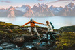 © EVERST - Couple man and woman hiking in Norway together in mountains family healthy lifestyle outdoor active vacations extreme adventure trip, friends trekking in Lyngen Alps - people crossing river in a wild