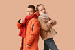 © Pixel-Shot - Cute little happy children in warm winter clothes showing thumb-up gesture on brown background