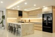 © Faisal Ai - A contemporary kitchen with light beige cabinetry, recessed ceiling lights, and a marble island, featuring minimalist barstools and sleek black appliances.