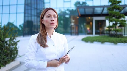 Wall Mural - Young doctor taking a break outside of her clinic