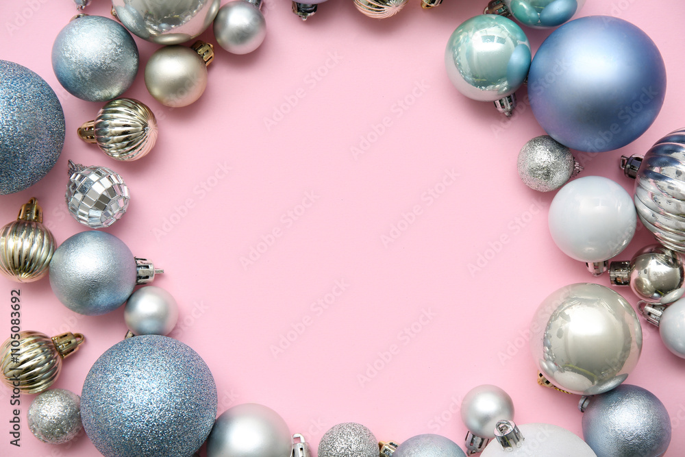 Frame made of Christmas balls on pink background