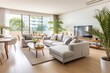 © larisikstefania - Spacious living room featuring wooden flooring, cozy upholstered furniture, and lively houseplants