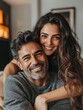 © Johannes - Smiling ethnic woman hugging her husband on the couch from behind in the living room. Middle eastern man having fun with his beautiful young wife on the couch. Mid adult indian man with latin woman.