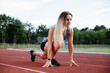 © ugis - Athlete in Starting Position on Running Track