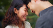 © M Einero/peopleimages.com - Happy couple, love and forehead touch outdoor in commitment, loyalty or support together. Japanese man, woman and romantic relationship on date at park for connection, care or trust on valentines day