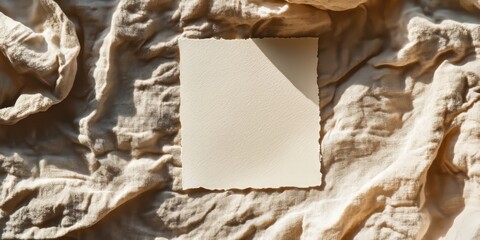 Poster - Blank paper sheet card positioned on a crumpled beige bed blanket, creating a mockup copy space. The soft warm sunlight shadows enhance the aesthetic minimal brand template in this flat lay setup.